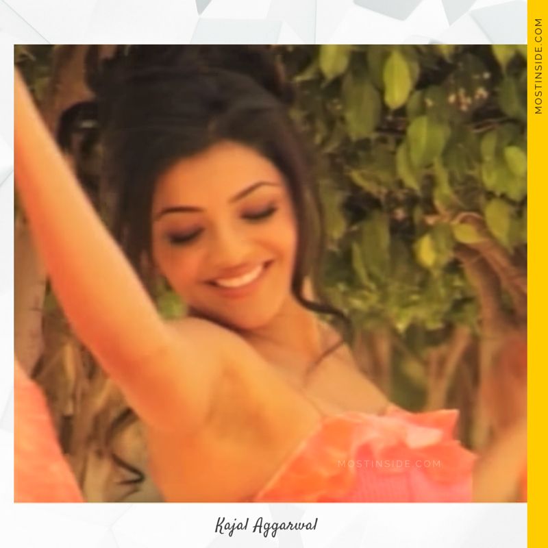 Kajal Aggarwal in printed pink and orange outfit with a floral designed lower concluded by a pair of silver pumps.