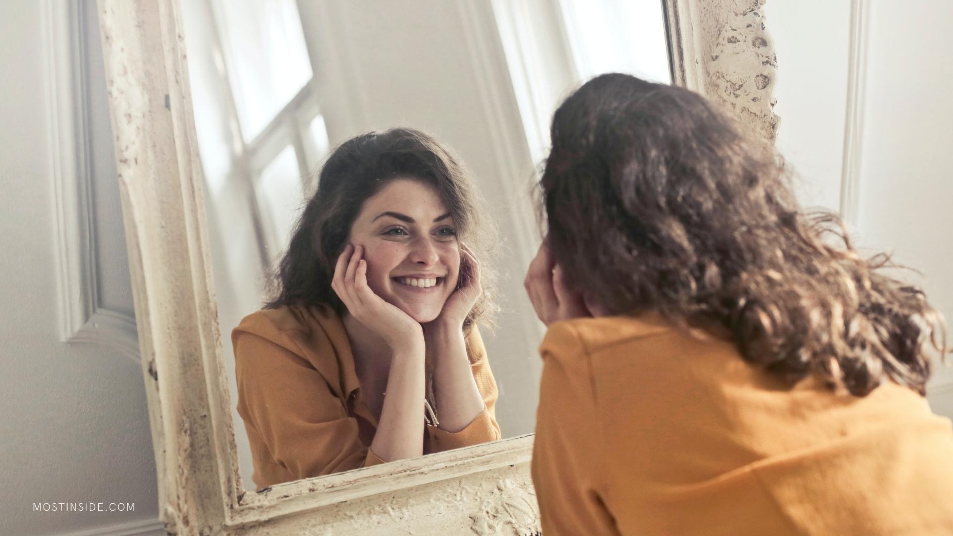 girl smiling in front of mirror