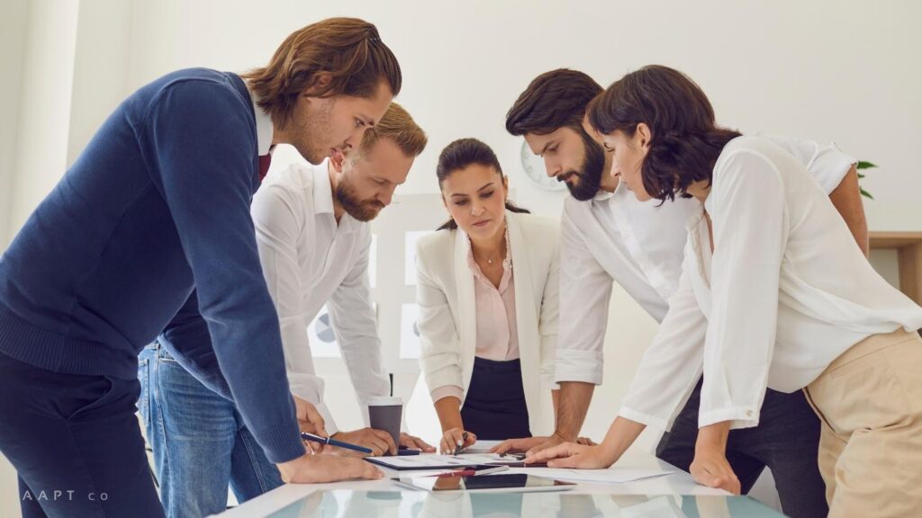A group of professionals review an enterprise report together.