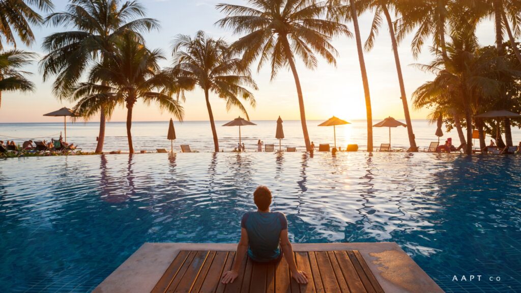 man sitting in front of luxury pool