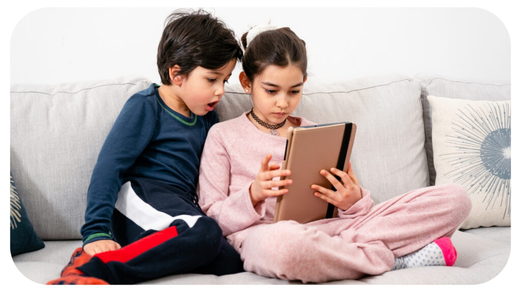 two kids watching ipad