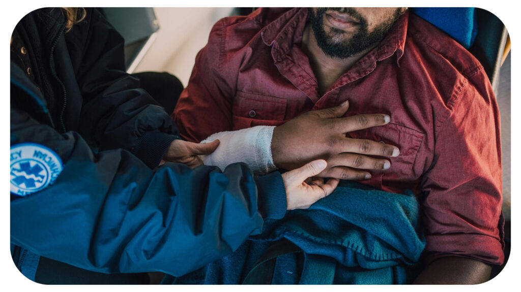 man lying down and being attended to by an emergency medical responder