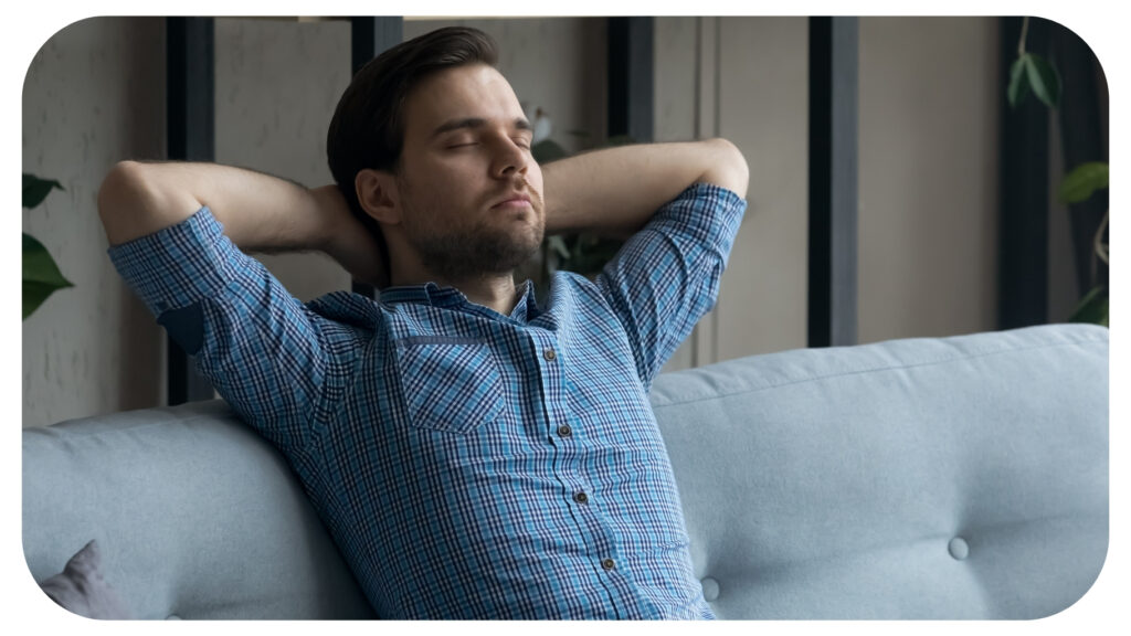 Calm peaceful millennial man taking break and deep breath