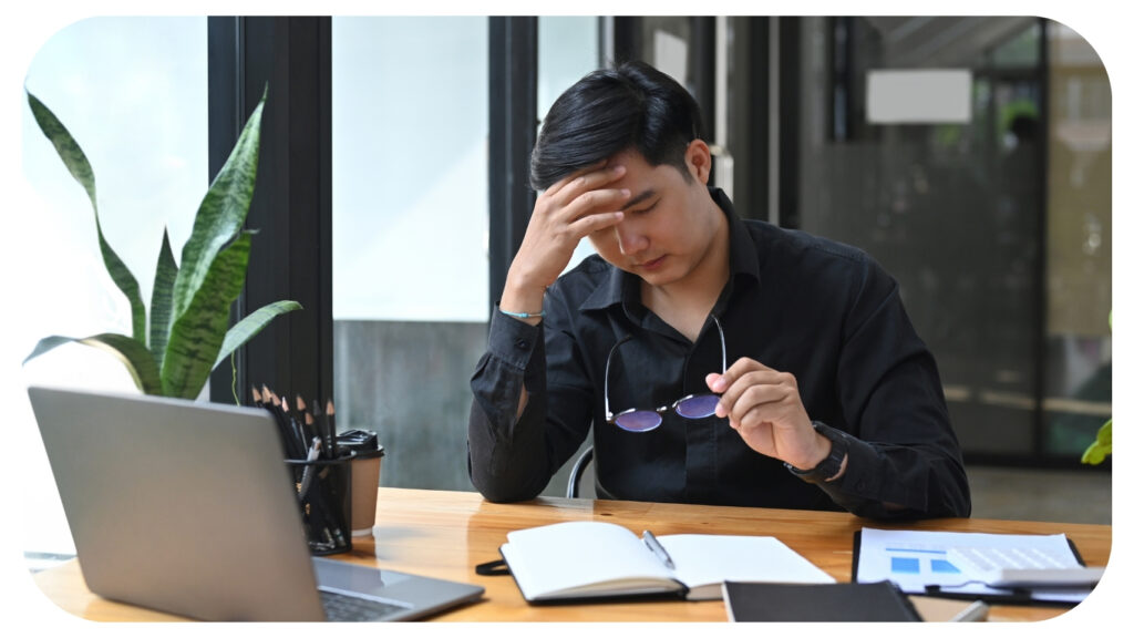 Tried businessman suffering stress working at office