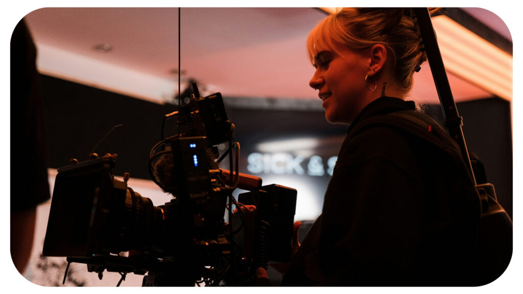 a woman standing in front of a camera