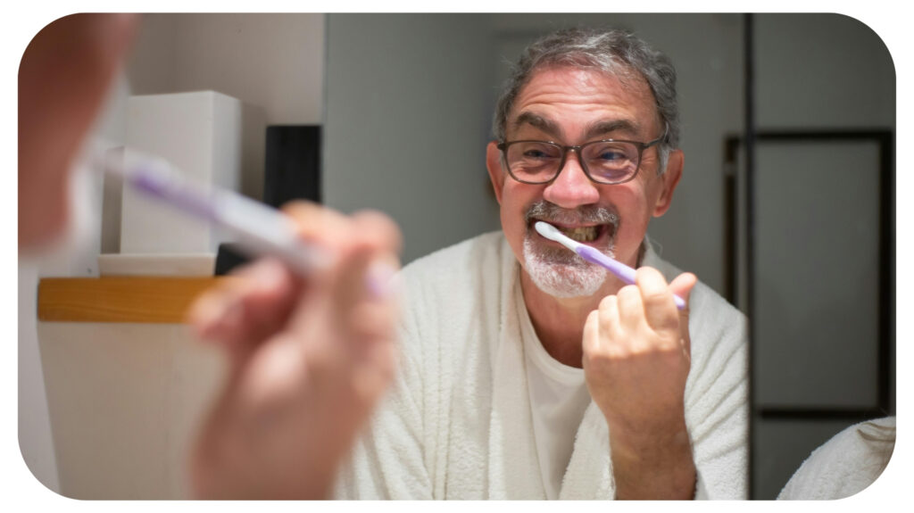 Elderly Man Brushing Teeth in Bathroom