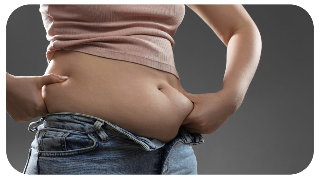 Woman Touching Belly Fat on Grey Background