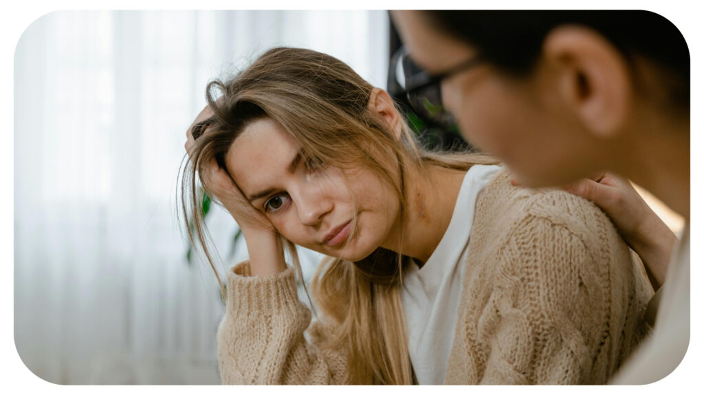 Person Patting the Stressed Woman on Her Shoulder.