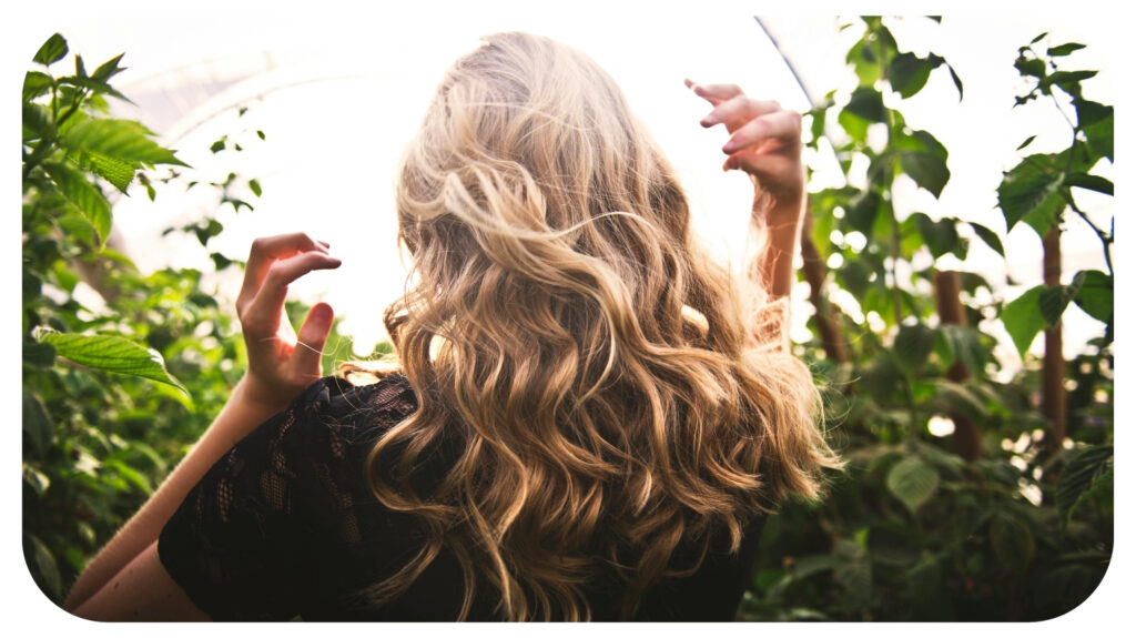 Blonde-haired Woman Standing Between Green Plants