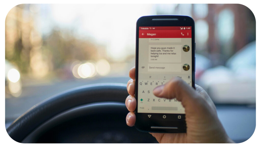 Person Sitting Inside Car With Black Android Smartphone Turned on