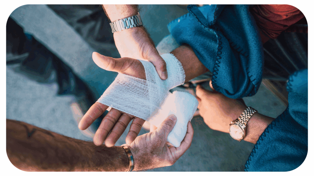 A healthcare professional wrapping a bandage around a patient’s injured hand, representing medical attention and the importance of documenting pain details for car accident claims.