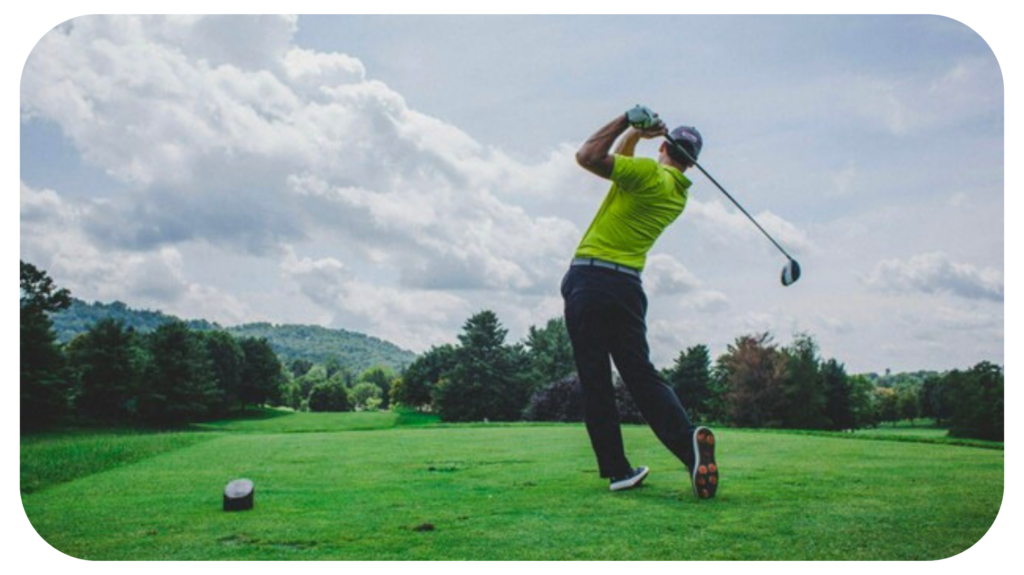 photo of man swinging golf driver