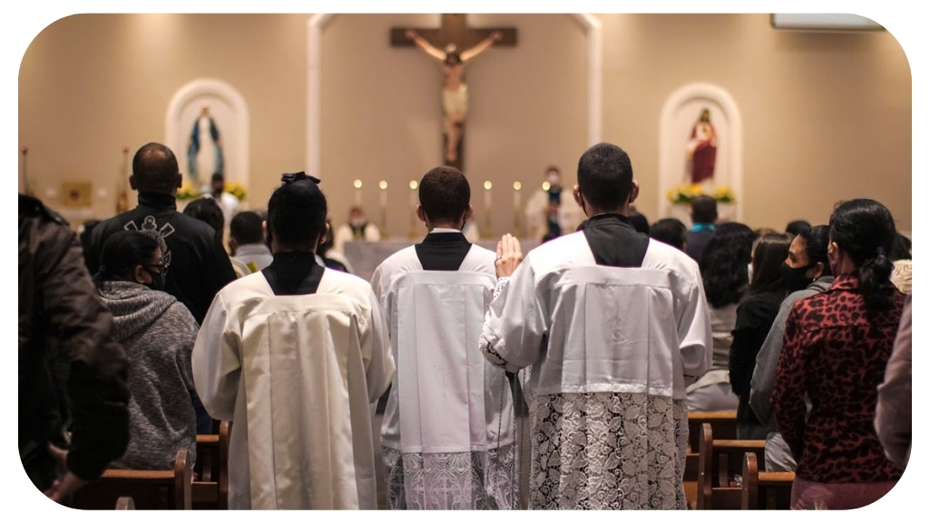 Catholic faithful gathered inside a church during prayer ceremony with altar servers standing near the altar representing traditional Catholic worship and spiritual devotion.