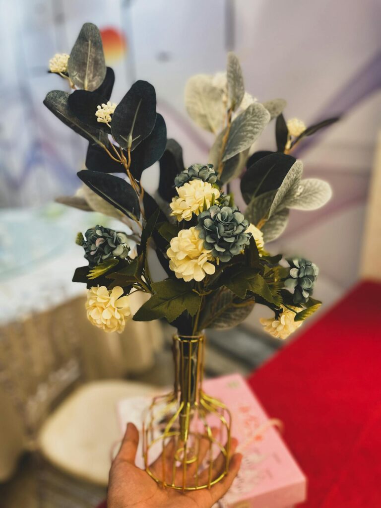 decorative artificial flower arrangement in a stylish vase placed on a table adding elegance and freshness to a modern home living space.