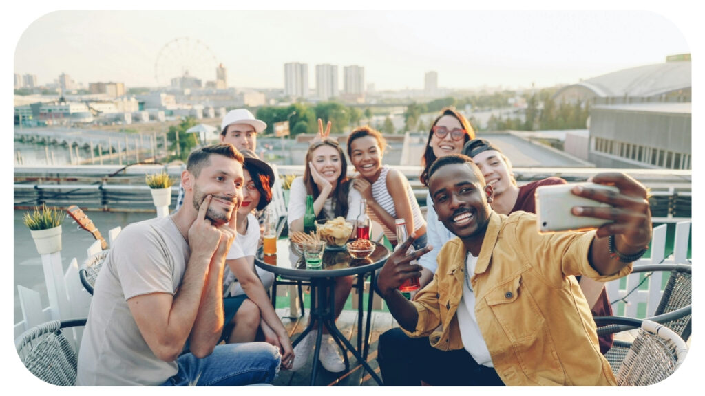 Group of friends enjoying a summer rooftop gathering and taking a selfie representing social events summer activities friendships and balancing a busy social calendar.