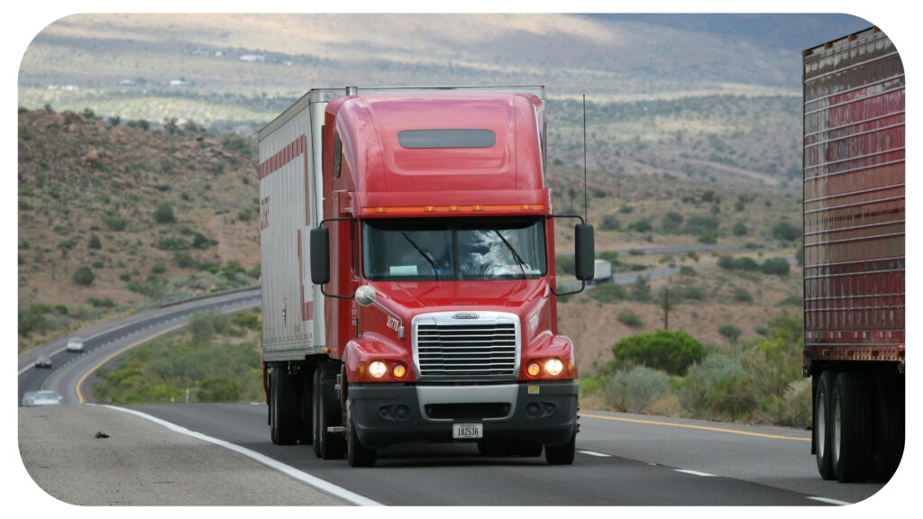 Large commercial truck driving on a U.S. highway representing highway travel road safety defensive driving and accident prevention awareness for drivers and families.