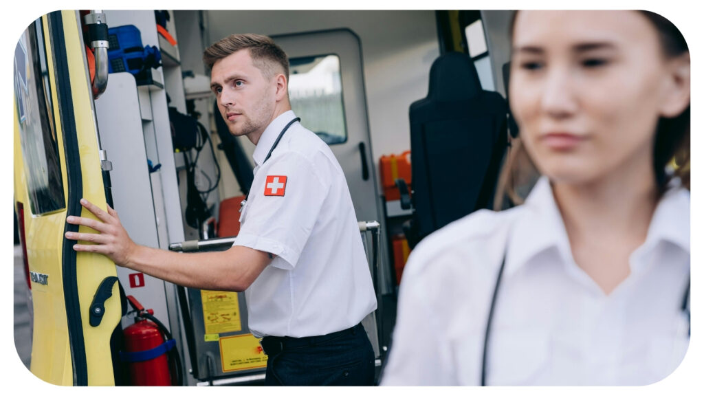 Emergency medical responders standing near an ambulance representing CPR training first aid certification emergency response education and life saving safety classes.