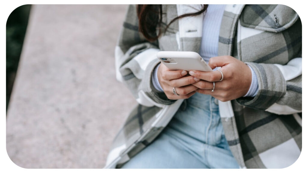 Person using a smartphone for digital communication social media engagement and mobile marketing representing technology driven customer acquisition and online business growth strategies.