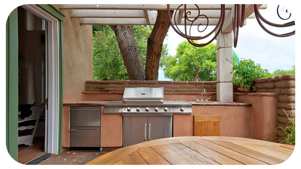 Stylish outdoor kitchen with barbecue grill preparation area and dining space surrounded by greenery creating a functional and inviting garden dining environment.