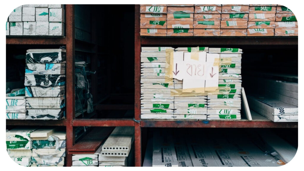 Stacked packaged building materials on warehouse shelving, representing responsible sourcing for sustainable construction.